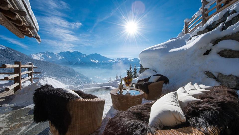 Luxury chalet terrace overlooking snowy alpine mountains representing refined winter travel companionship