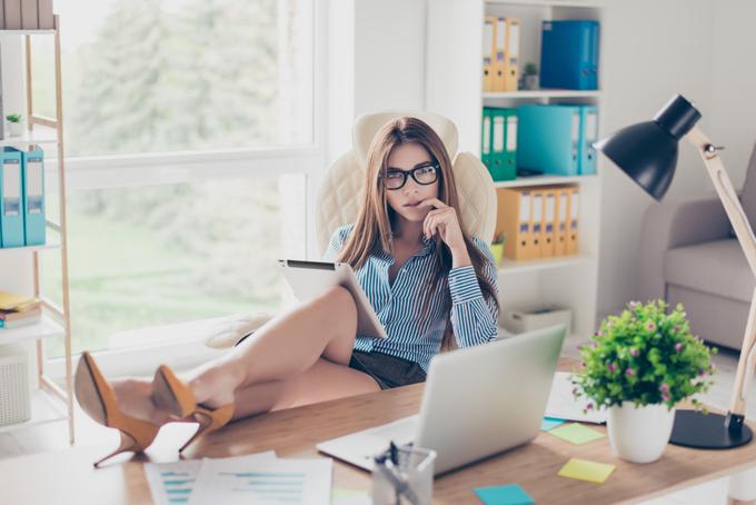 Elegant woman in a refined office setting representing discreet luxury companionship during business travel