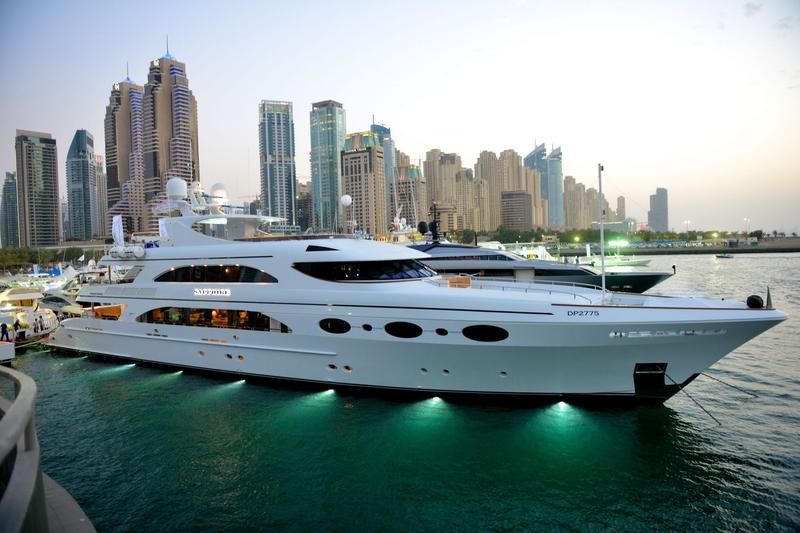 Luxury yacht in Dubai marina at sunset with skyline view